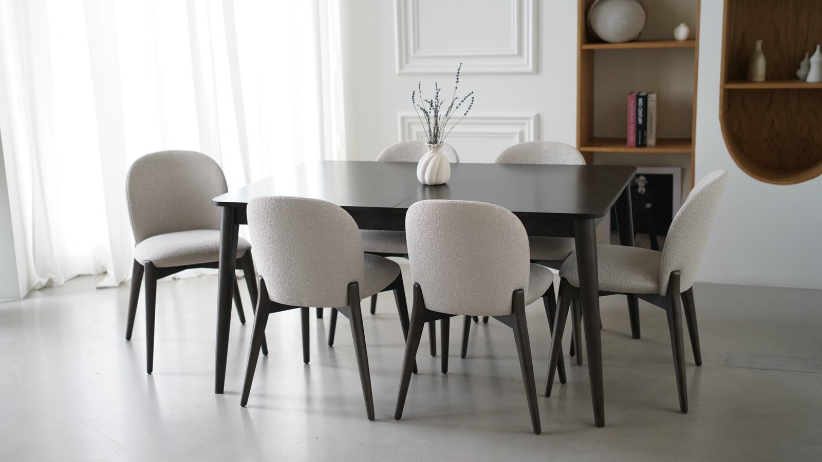 An Acobian table and upholstered chairs in a bright interior